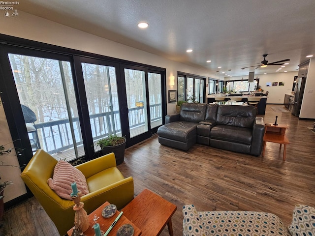 living room with wood-type flooring and ceiling fan