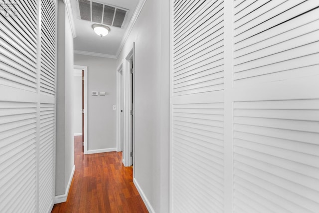 corridor with crown molding and dark wood-type flooring