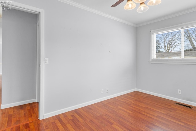 spare room with hardwood / wood-style flooring, crown molding, and ceiling fan