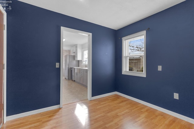 spare room with wood-type flooring