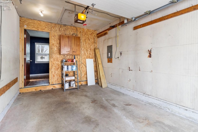 garage with a garage door opener and electric panel