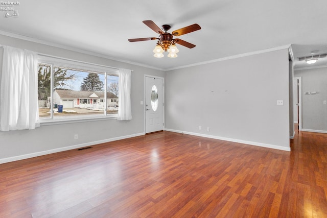 interior space with hardwood / wood-style flooring, ornamental molding, and ceiling fan