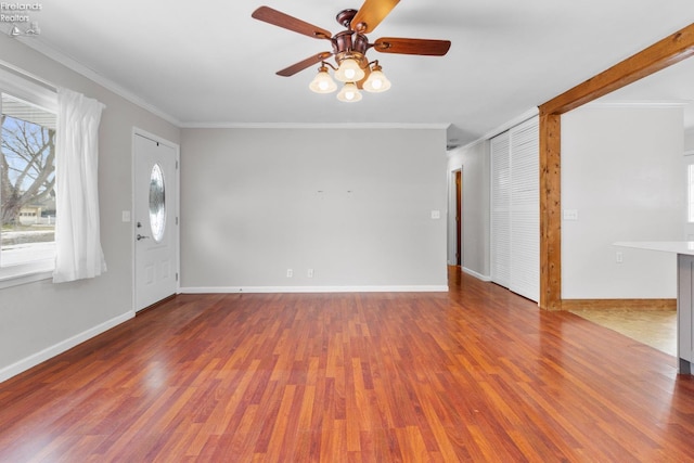 unfurnished room featuring crown molding, ceiling fan, and wood-type flooring