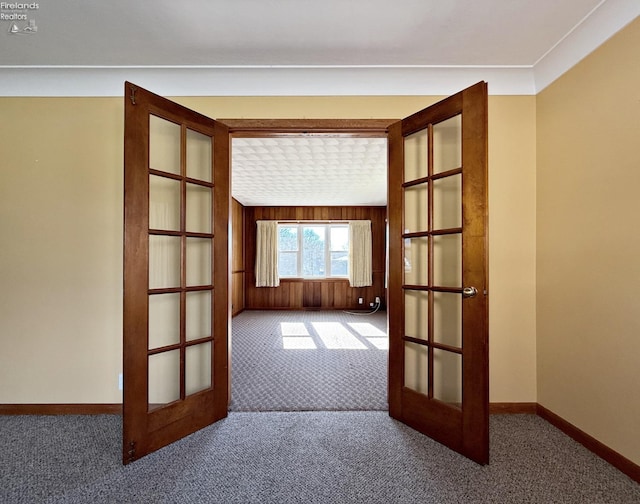 empty room featuring carpet flooring and french doors