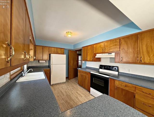 kitchen with sink, light hardwood / wood-style flooring, range with electric stovetop, decorative backsplash, and white fridge