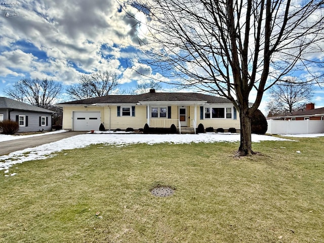 single story home featuring a garage and a front lawn