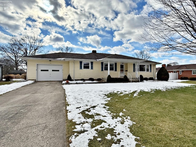 single story home featuring a garage and a lawn