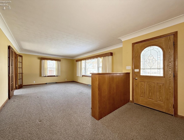 carpeted foyer entrance with crown molding