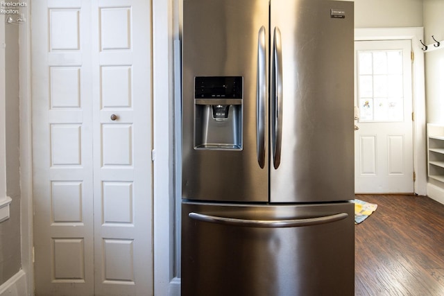 kitchen with dark wood-type flooring and stainless steel fridge