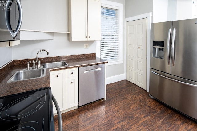 kitchen featuring white cabinetry, stainless steel appliances, dark hardwood / wood-style flooring, and sink