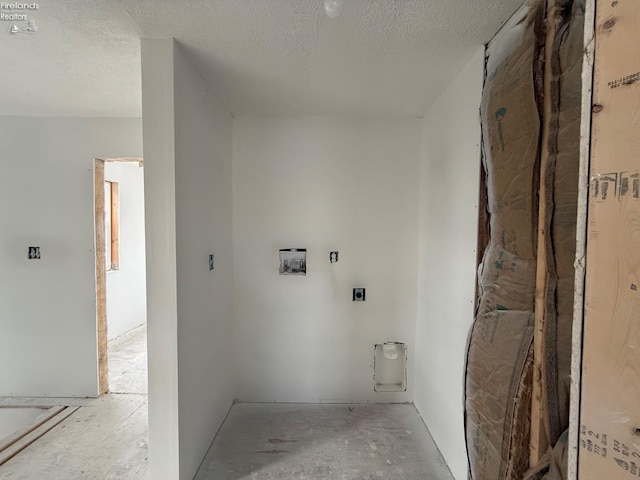 laundry room featuring hookup for an electric dryer and a textured ceiling