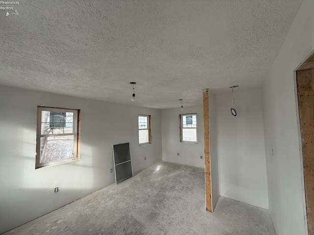 unfurnished room featuring a textured ceiling