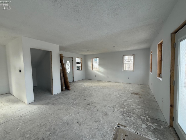 unfurnished living room featuring a textured ceiling