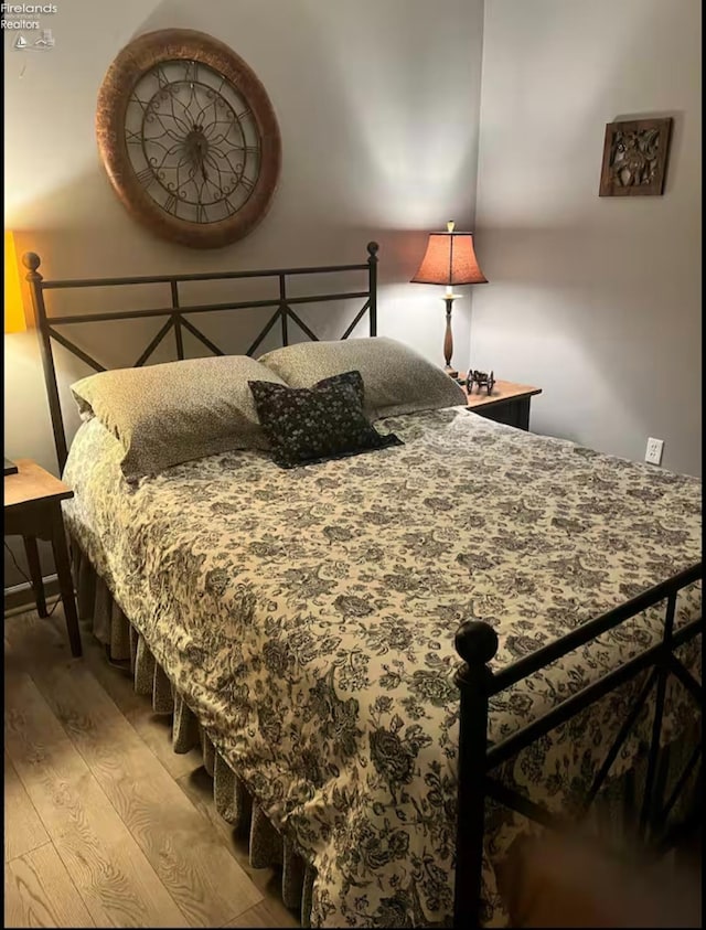 bedroom with hardwood / wood-style floors