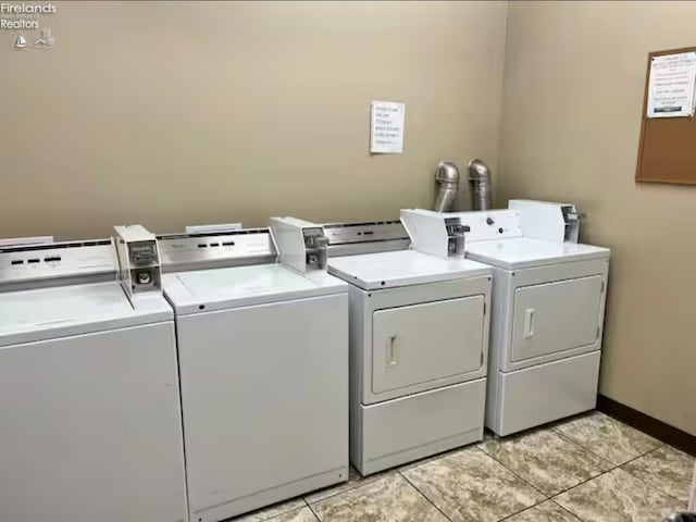 washroom featuring washer and dryer and light tile patterned floors