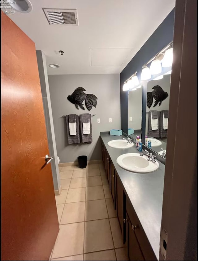 bathroom featuring tile patterned floors, toilet, and vanity