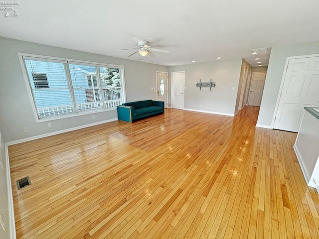 unfurnished room with ceiling fan and light wood-type flooring