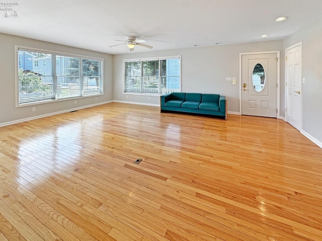 unfurnished living room with ceiling fan and light wood-type flooring