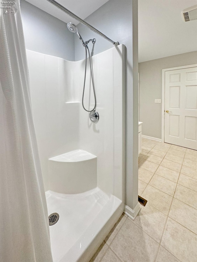 bathroom featuring tile patterned flooring and a shower with shower curtain