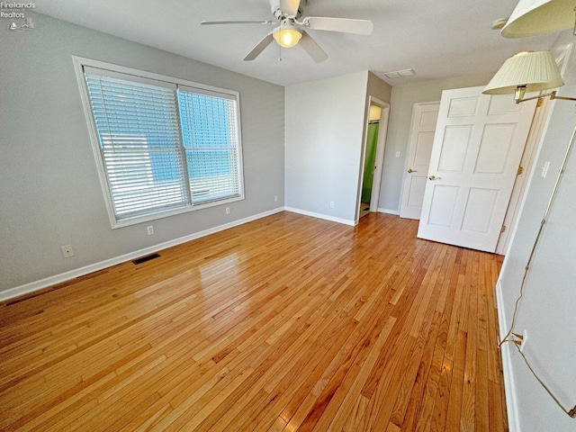 unfurnished room with ceiling fan and light hardwood / wood-style floors