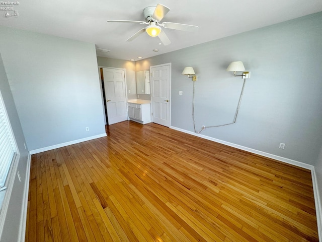 spare room with hardwood / wood-style flooring and ceiling fan