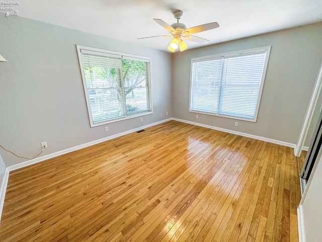 spare room featuring ceiling fan and light hardwood / wood-style flooring