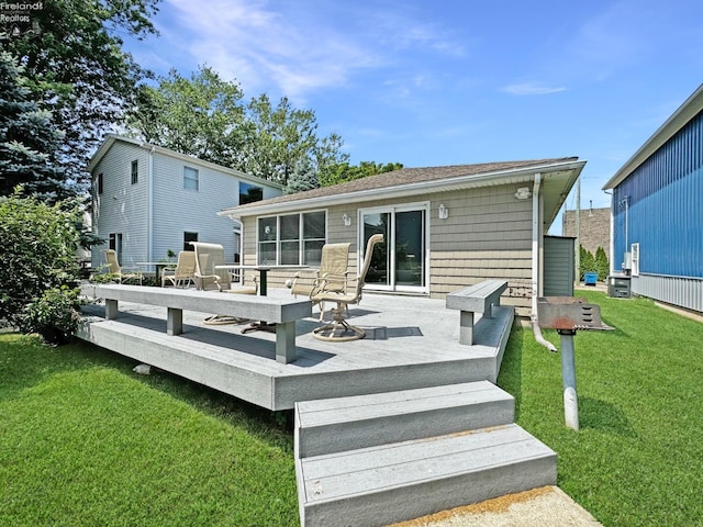 back of house with a wooden deck and a lawn