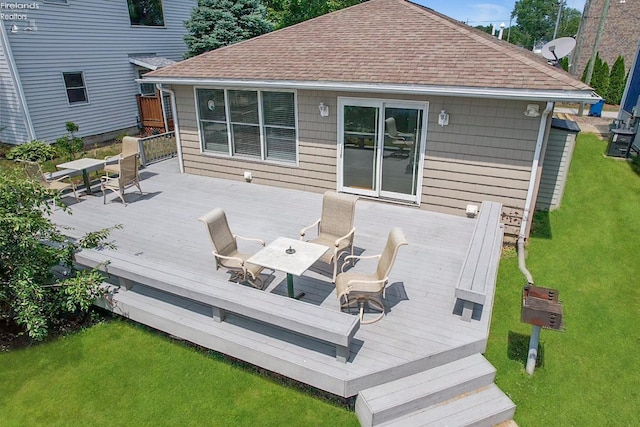 wooden terrace with a yard