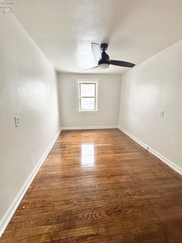 spare room featuring dark hardwood / wood-style floors and ceiling fan