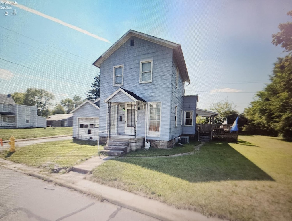 view of front of home with a garage, an outdoor structure, a front yard, and a porch