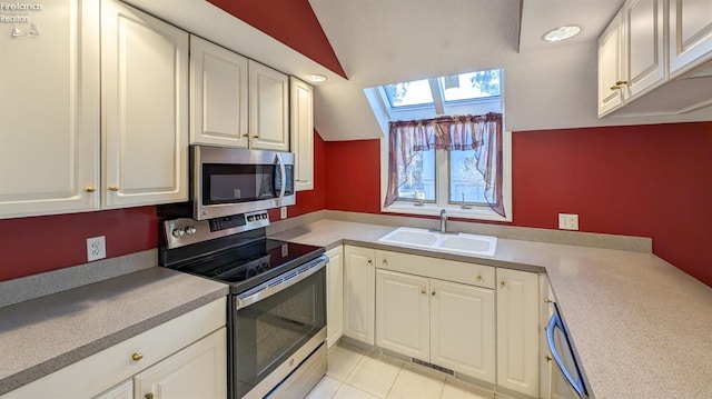 kitchen with white cabinetry, stainless steel appliances, and sink