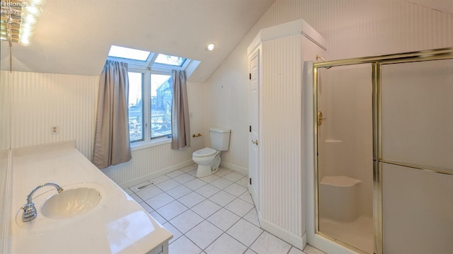 bathroom with vanity, tile patterned flooring, a shower with door, and vaulted ceiling with skylight