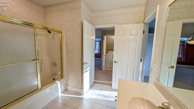 bathroom with vanity, washer / clothes dryer, tile patterned floors, and combined bath / shower with glass door