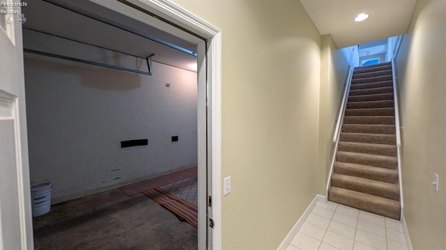 stairway featuring tile patterned flooring