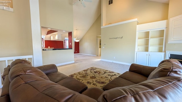 carpeted living room with a towering ceiling and ceiling fan