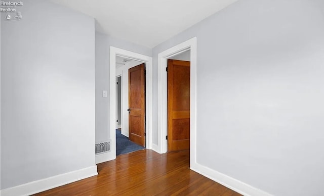 hall with dark wood-type flooring