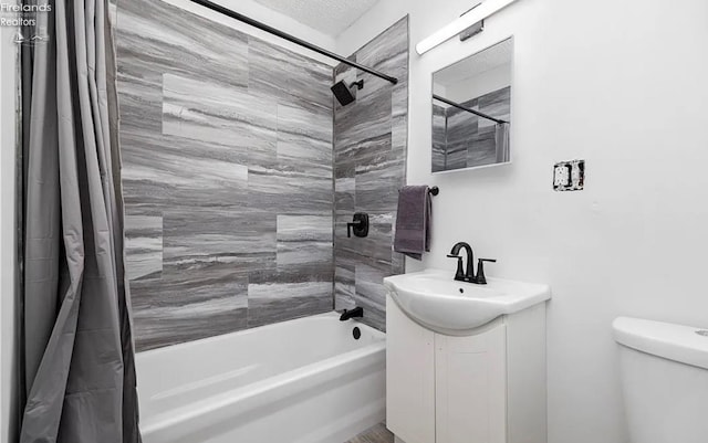 full bathroom with vanity, toilet, a textured ceiling, and shower / bath combo