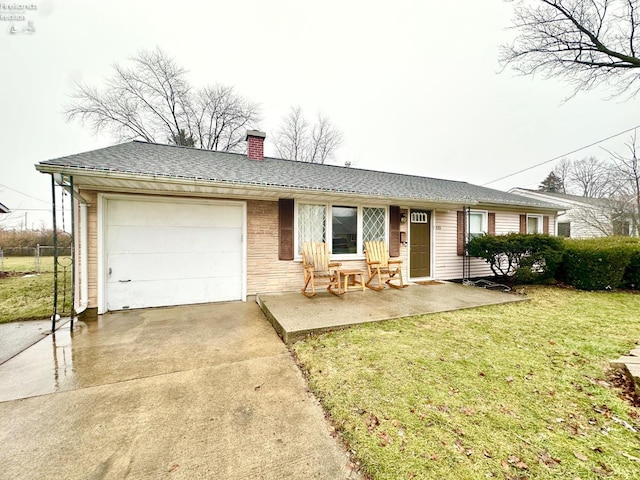 ranch-style home with a garage and a front lawn