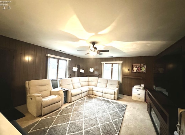 carpeted living room featuring ceiling fan