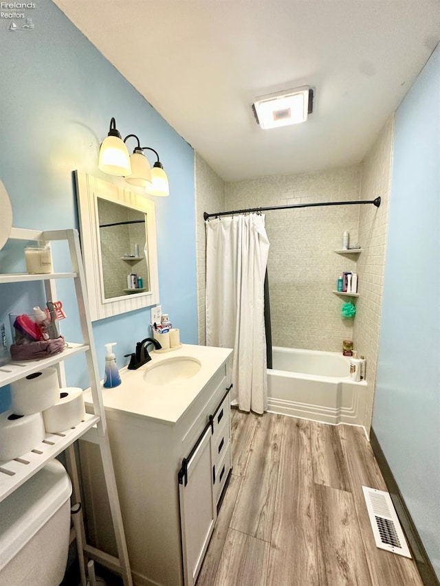 full bathroom featuring vanity, toilet, shower / tub combo, and hardwood / wood-style floors