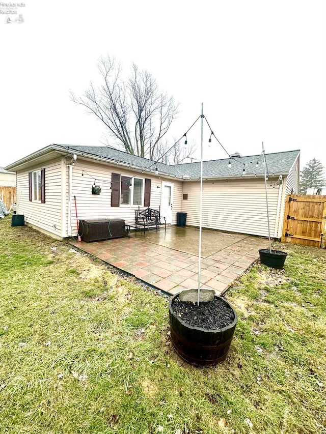 rear view of house with a yard and a patio area