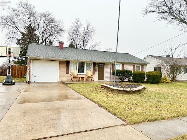 ranch-style home with a garage and a front lawn