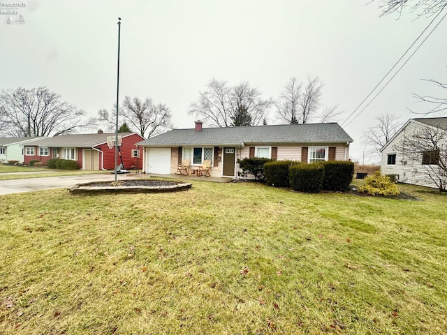 ranch-style home featuring a garage and a front yard