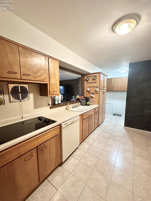 kitchen featuring white dishwasher, sink, and black electric cooktop