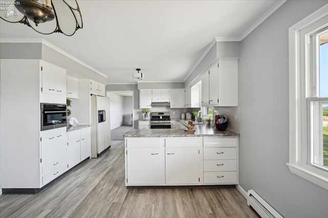 kitchen featuring sink, white cabinets, baseboard heating, stainless steel appliances, and crown molding