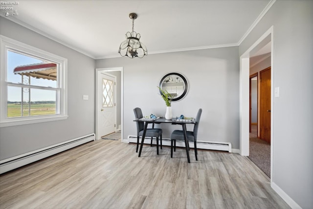 dining area featuring a baseboard radiator, ornamental molding, a chandelier, and light wood-type flooring