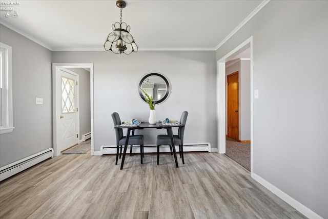 dining room with crown molding, an inviting chandelier, baseboard heating, and light hardwood / wood-style flooring