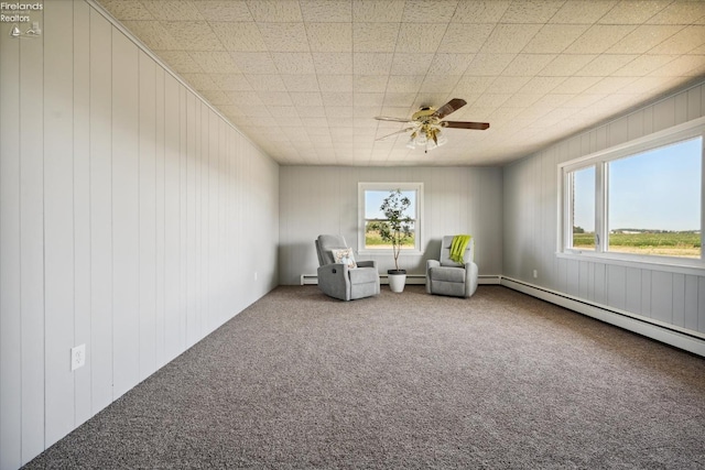 unfurnished room with baseboard heating, ceiling fan, and carpet flooring