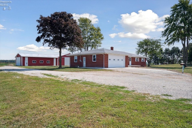 single story home with a garage and a front yard