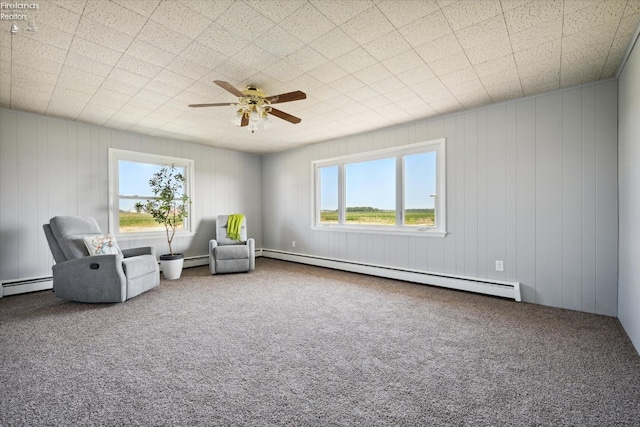 unfurnished room featuring a baseboard radiator, ceiling fan, and carpet flooring